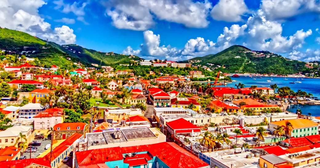 Panoramic view over town in US Virgin islands, with blue sky and hills in background