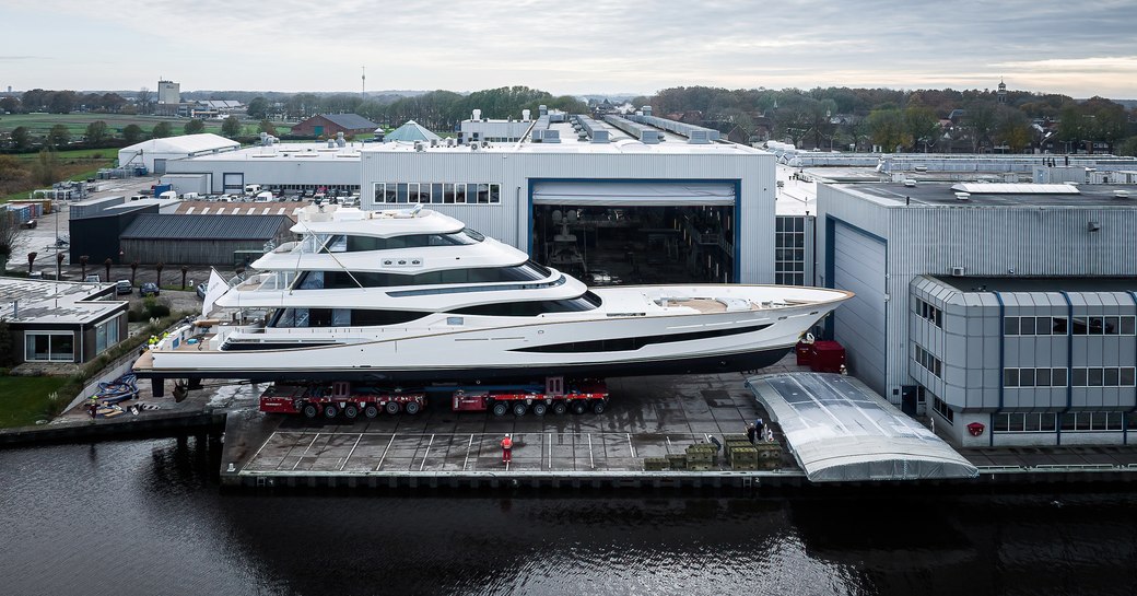 Overview of sport fishing yacht Project 406 on the tarmac outside a construction shed