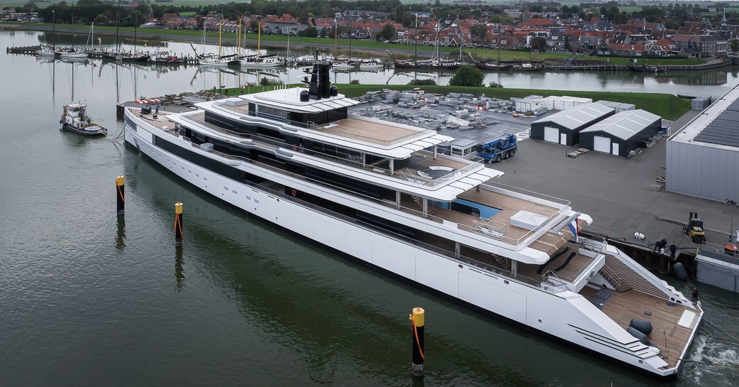 Aft view of Feadship Project 1011 emerging from construction shed.