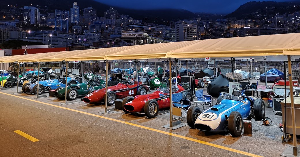 Line up of historic grand prix cars in garage at Monaco Historic Grand Prix event.