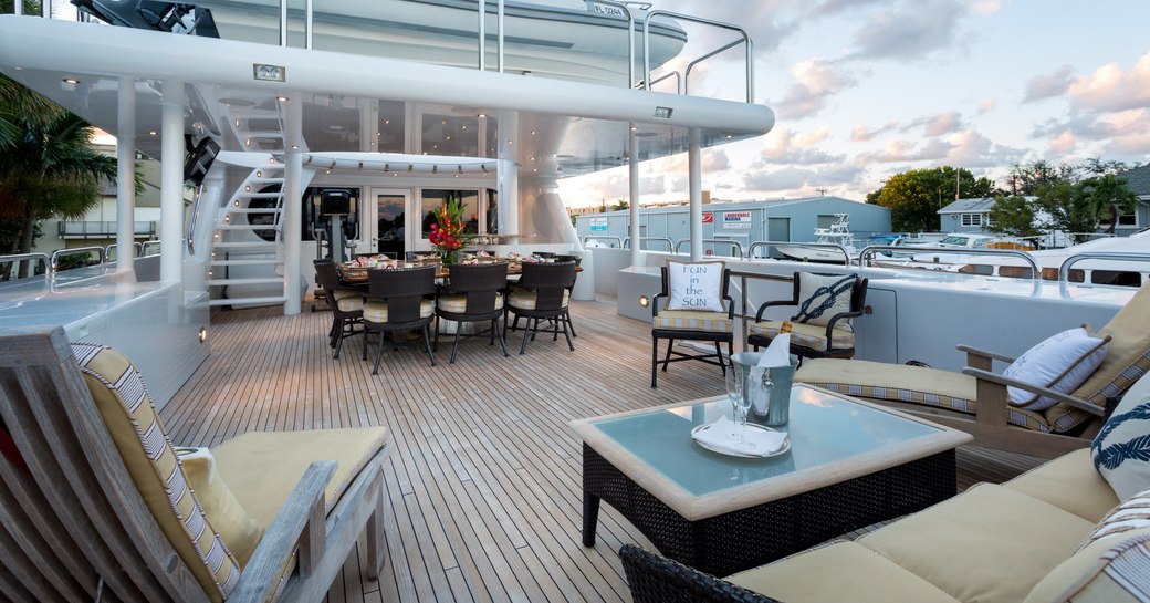 alfresco dining area and sun loungers on the upper deck aft of superyacht STARSHIP 