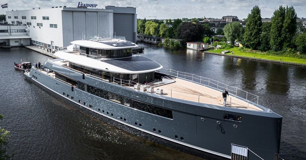 Superyachts being towed out of construction shed at Feadship