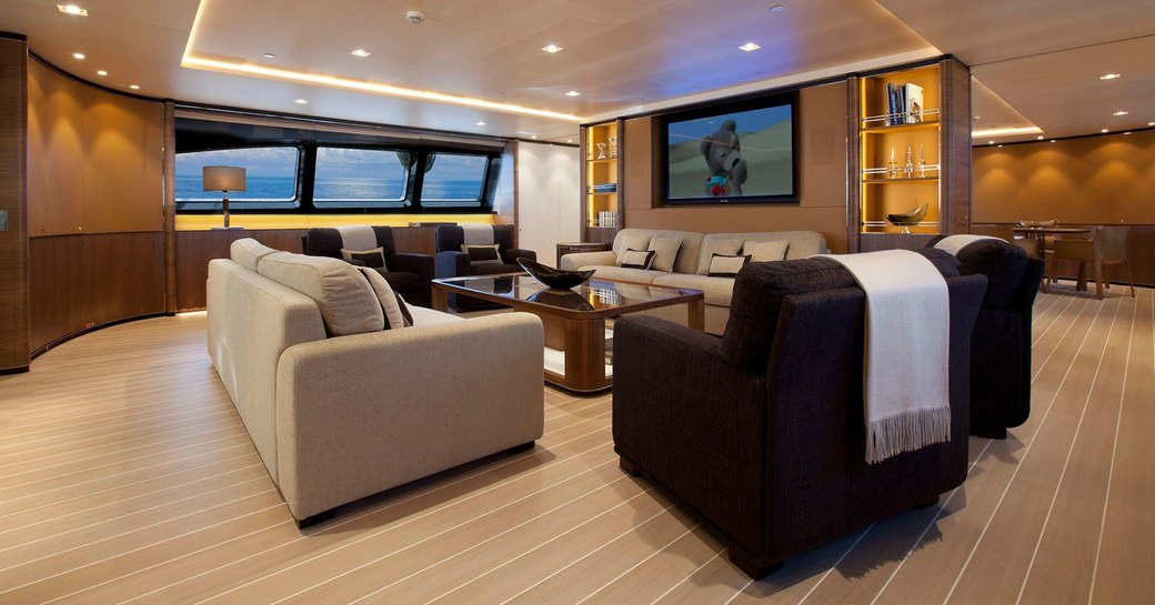 deep sofas and armchairs form a sociable seating area in the main salon of superyacht FIDELIS 