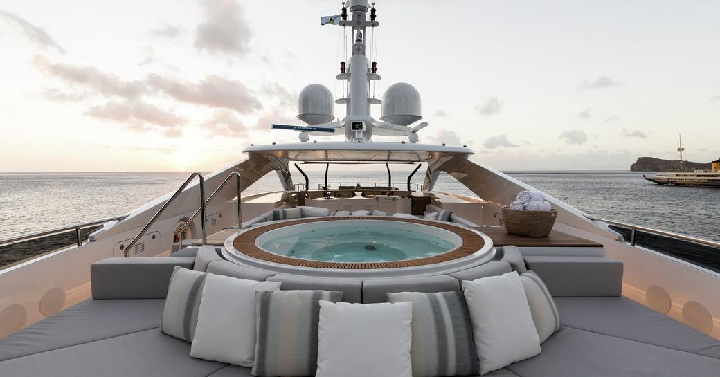 Jacuzzi surrounded by sunpads on the sundeck of superyacht LAURENTIA 