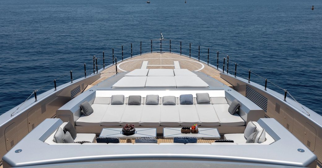 Overview of the bow onboard charter yacht SARASTAR, with helipad and exterior lounge area with sun pads