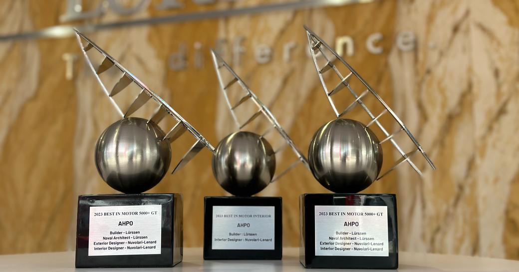Close-up of AHPO's three awards in front of Lurssen sign