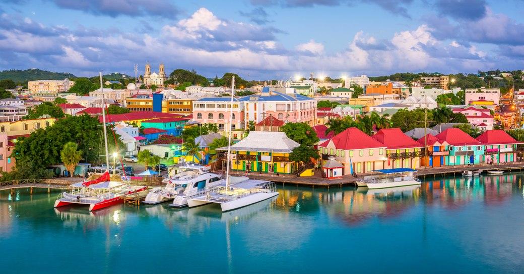 Elevated view looking over a town with brightly colored buildings on the Caribbean island of Antigua