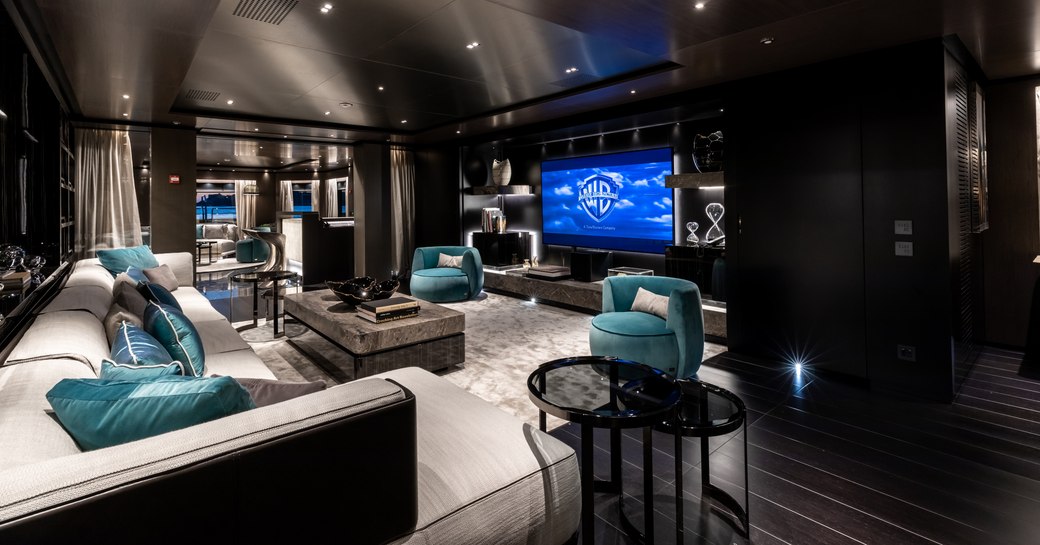 sofa facing a large widescreen TV in the modern main salon aboard luxury yacht SOLO 