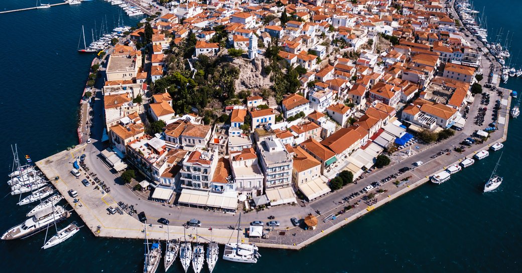 Aerial view looking down on superyacht charters berthed in Poros Port, Greece