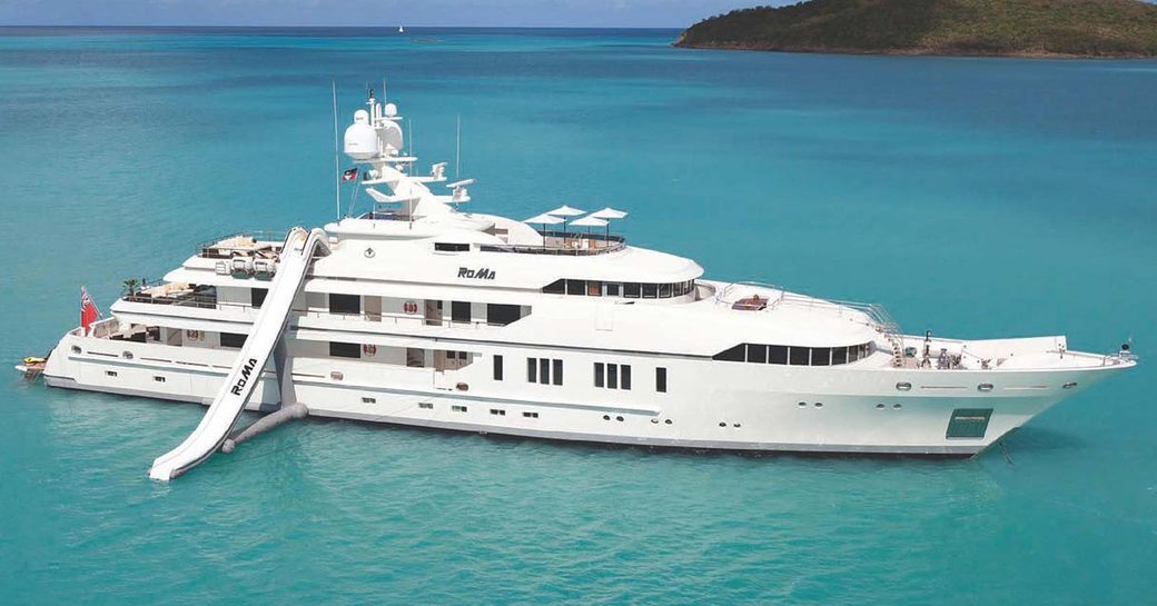 superyacht ROMA at anchor with an inflatable water slide on a private yacht charter