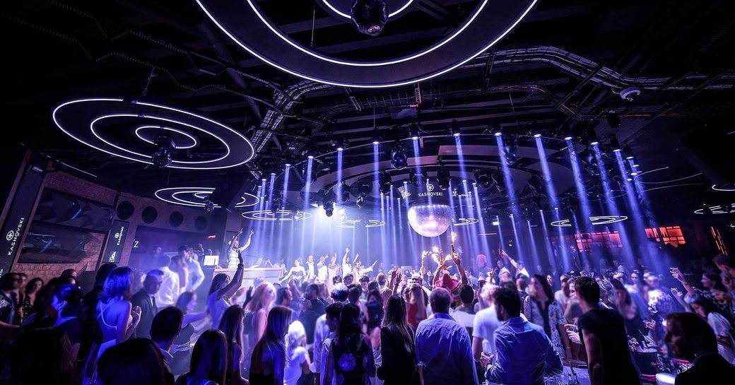jimmy'z club in monaco, with people on the dancefloor and lights on the ceiling