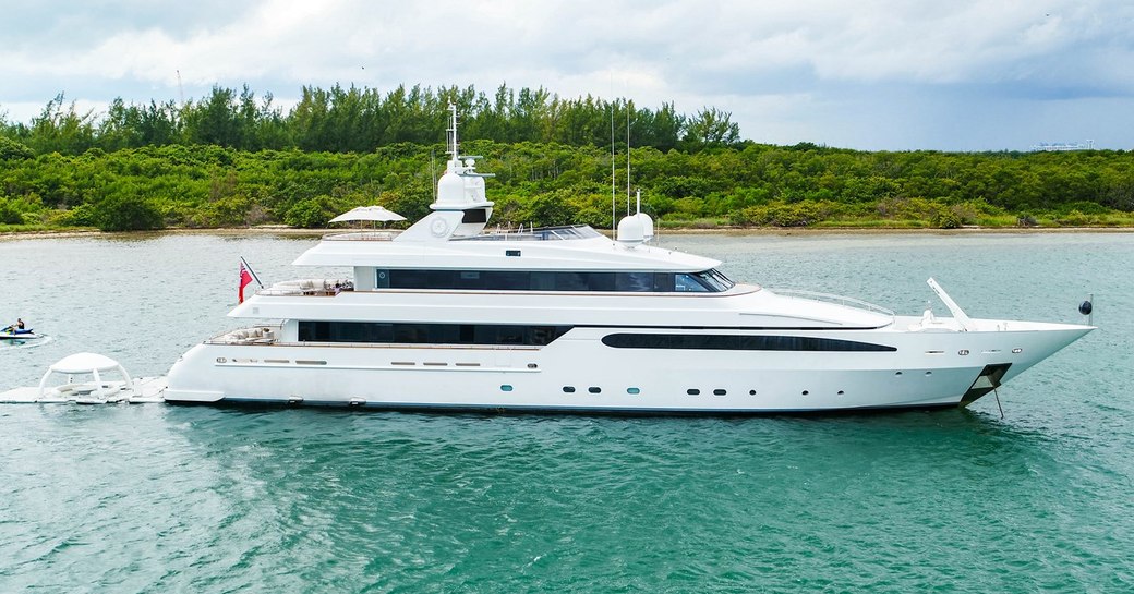 Charter yacht ARTEMISEA underway, with green scenery in the background