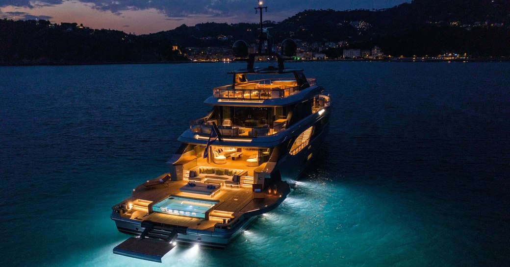 View of aft of lit up superyacht REBECA