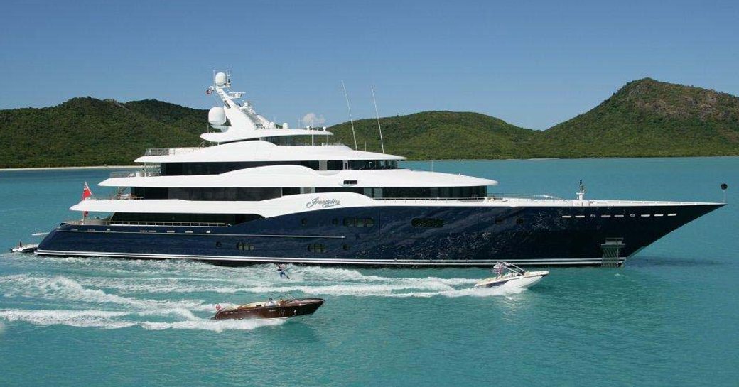 Charter yacht AMARYLLIS at sea with a tender speeding alongside