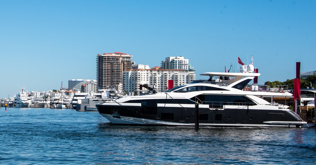 Superyacht underway in a Fort Lauderdale marina, more yachts berthed in background.