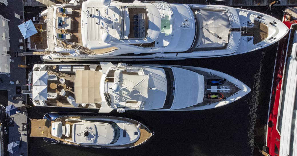 Overhead view looking down on three motor yachts lined up 