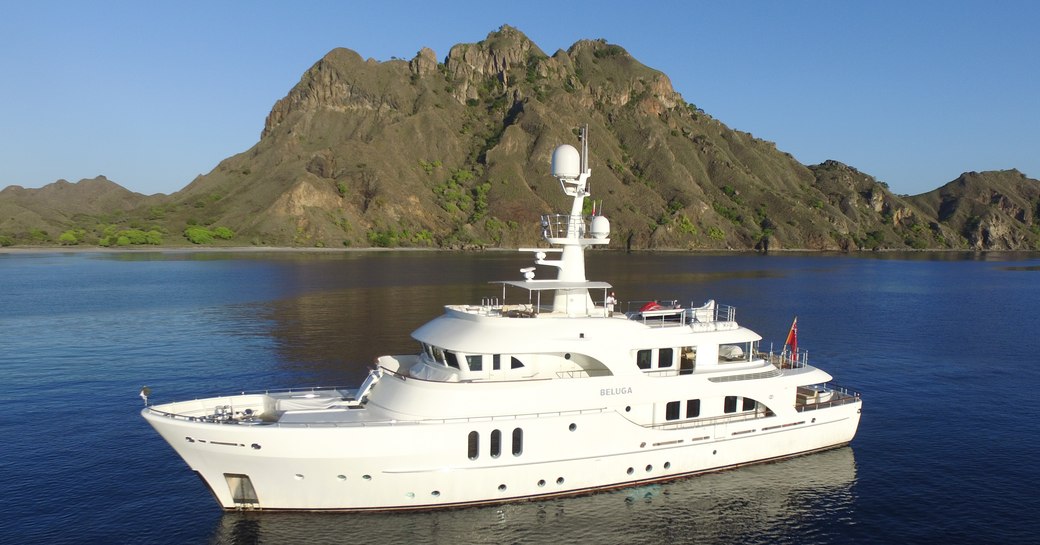 Superyacht Beluga on water in front of hills