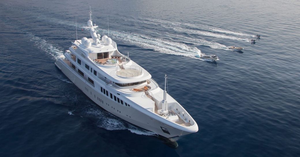 Charter yacht PLAN B and tenders underway at sea