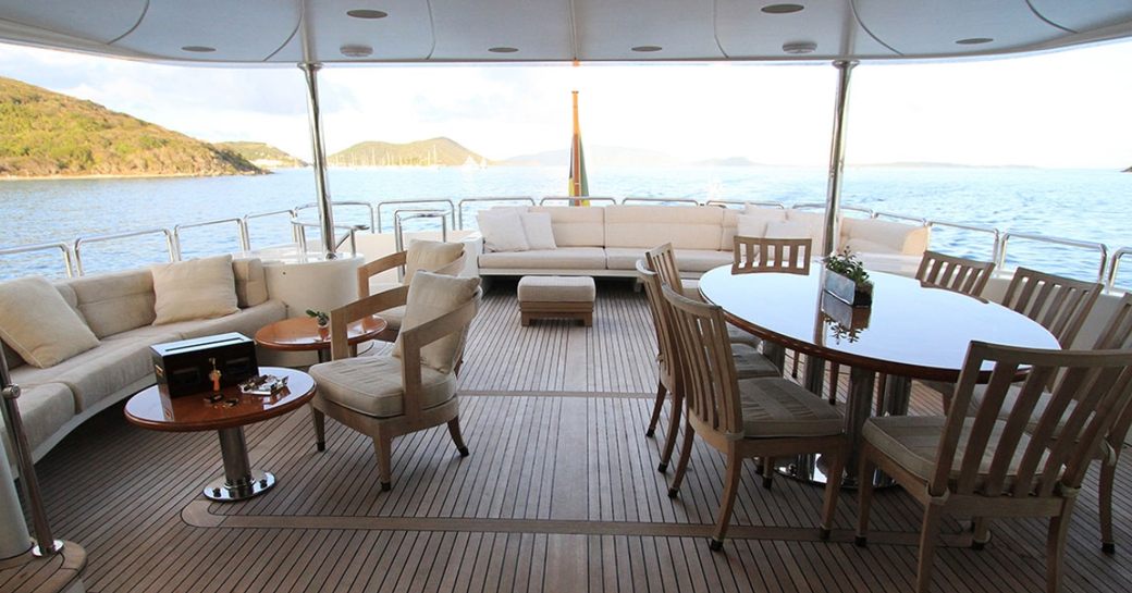 al fresco dining table and seating areas on the upper deck aft of superyacht BRUNELLO