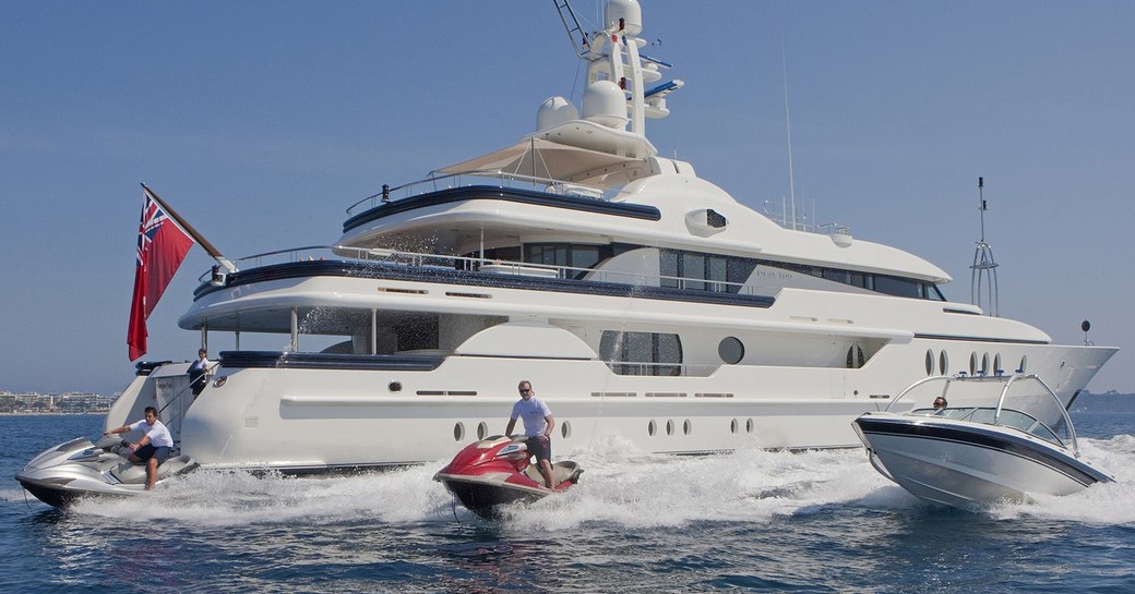 superyacht Deja Too anchors on a charter while jet skis and tender takes to the waters