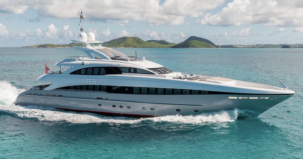 Charter yacht G3 underway, surrounded by sea and an island in the far distance