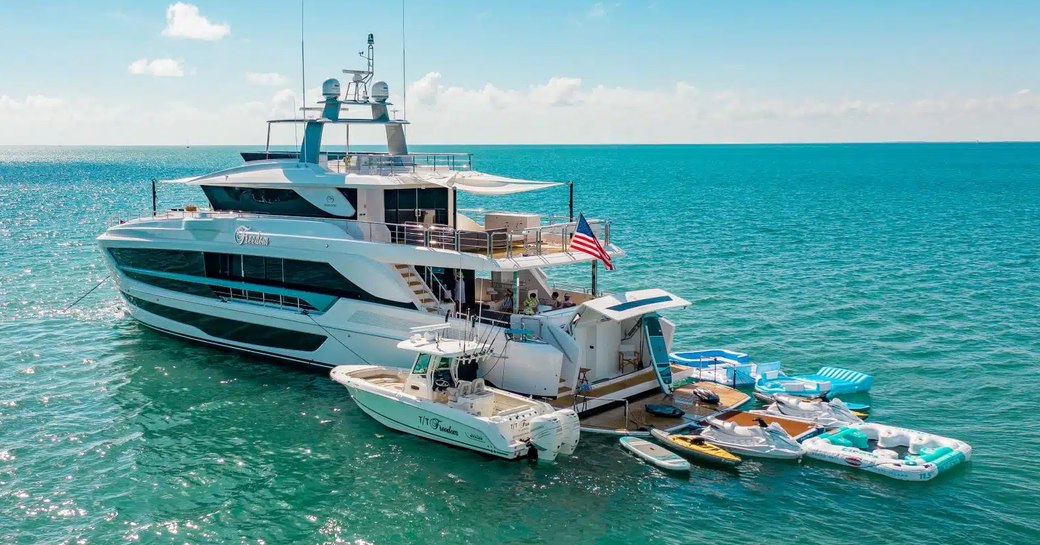 Aft view of charter yacht FREEDOM at anchor with all her water toys adjacent and ready to launch