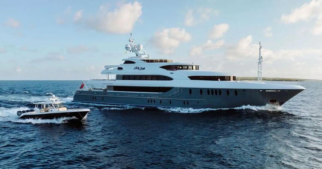 Charter yacht LADY BETH underway at sea with tender alongside