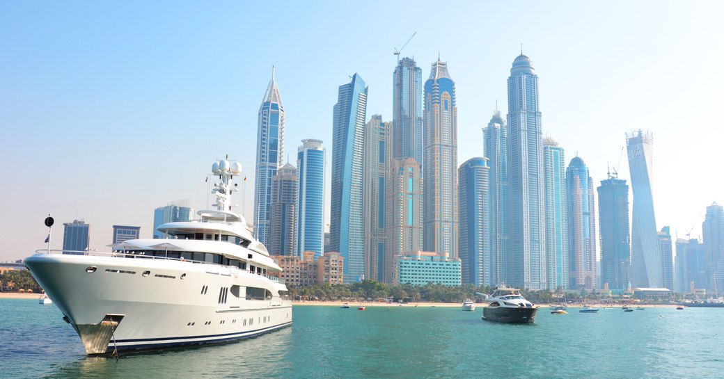 Superyacht with skyscraper cityscape in the background