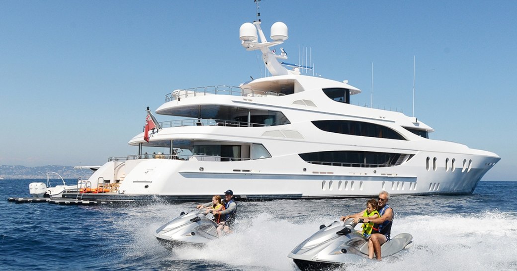 motor yacht LIBERTY anchors on a yacht charter as guests try out the water toys