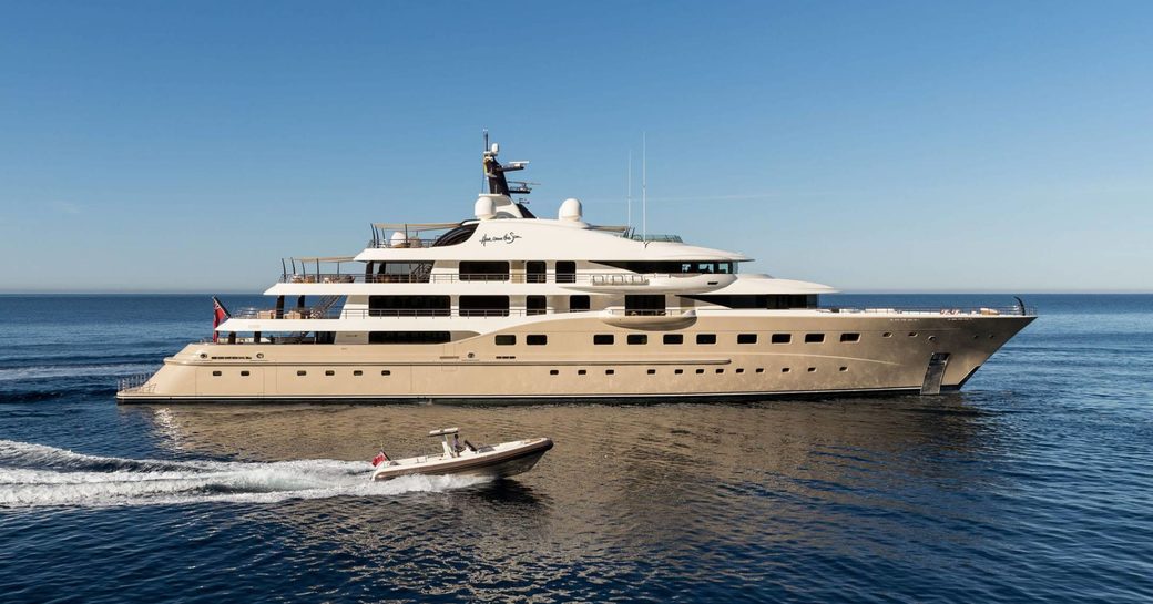 superyacht ‘Here Comes The Sun’ cruises alongside tender on a luxury yacht charter