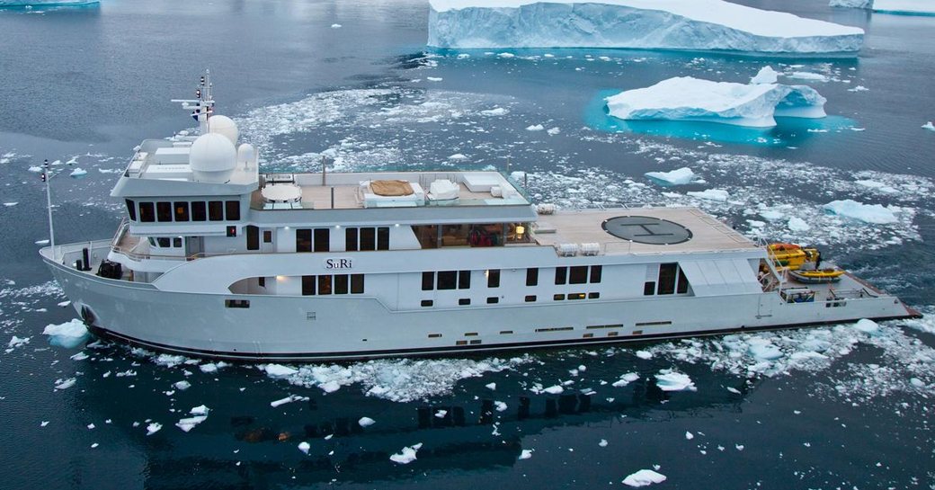 Charter yacht SURI underway, surrounded by mountains and glaciers