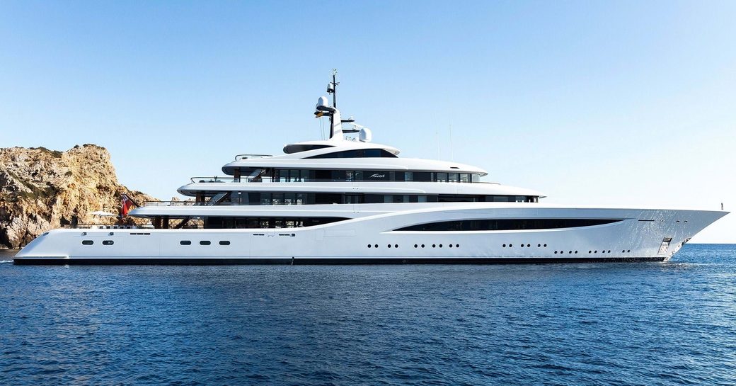 Charter yacht SOPHIA at anchor by some cliffs