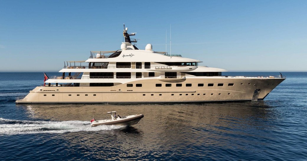 motor yacht Here Comes The Sun cruising alongside tender on a luxury yacht charter