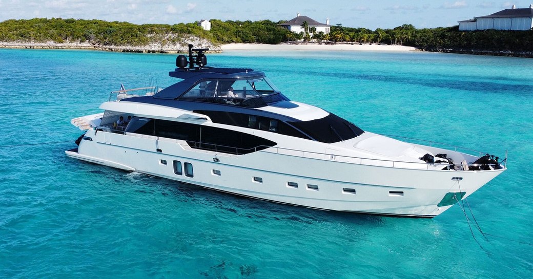 Charter yacht C-DAZE at anchor, surrounded by sea and an island in the background