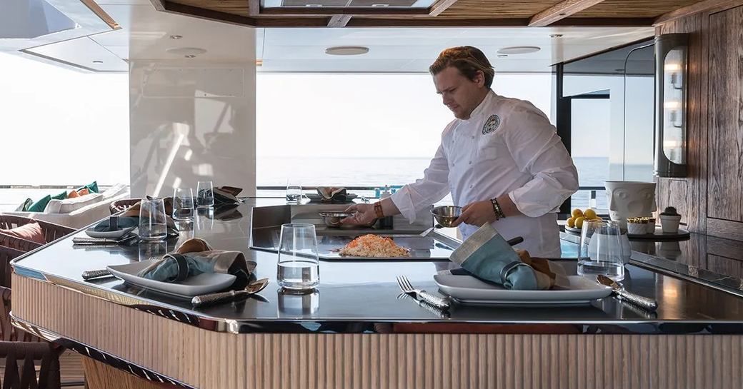 Chef onboard private yacht charter KING BENJI preparing a meal