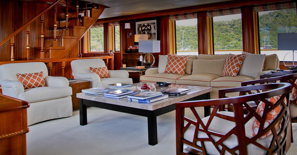 plush cream sofas and armchairs in the main salon aboard motor yacht M4