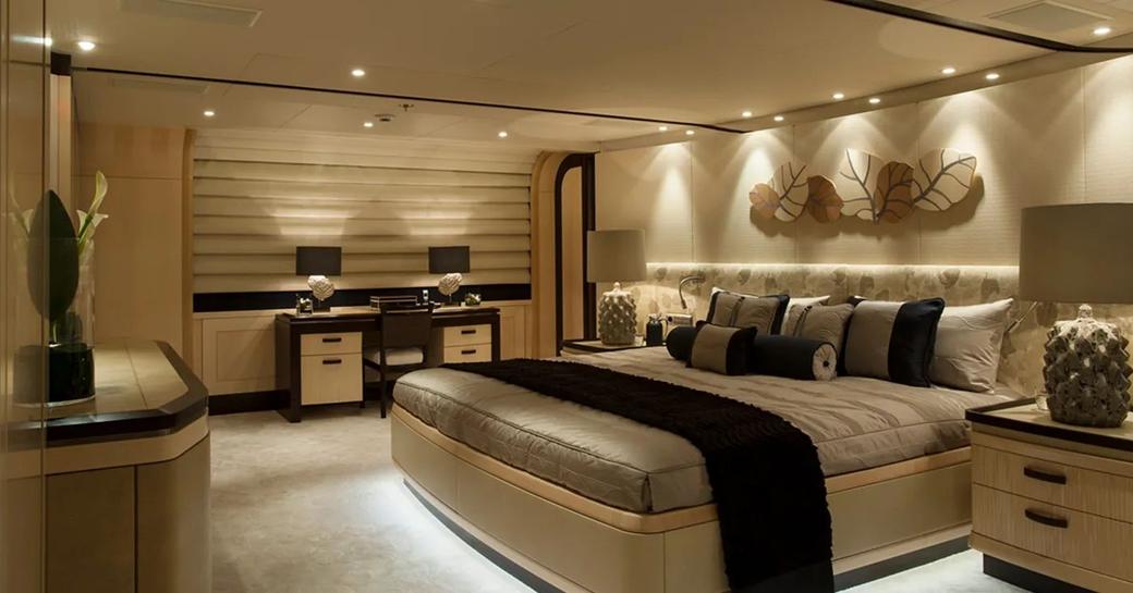 Large cabin with double bed and desks on superyacht Sea Rhapsody