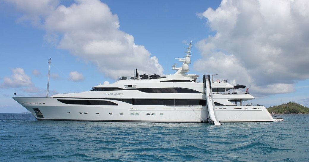 motor yacht silver angel docked with inflatable water slide