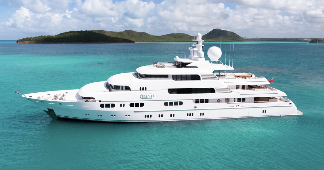 Superyacht charter TITANIA at anchor surrounded by teal waters