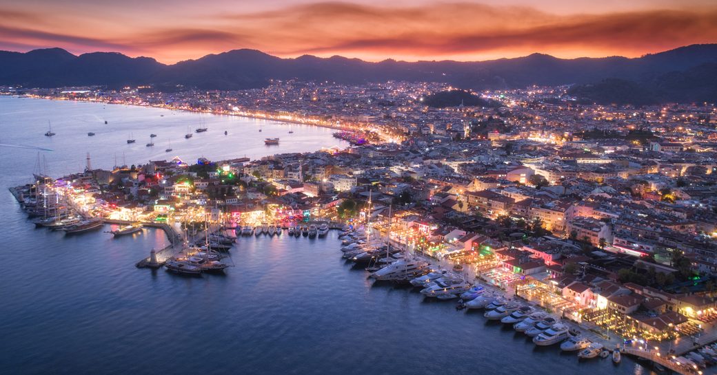 Aerial view of motor yacht charters berthed in Muttaş Marmaris Marina at dusk