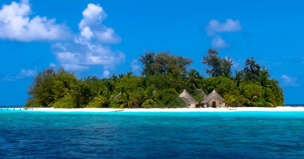 An island in the Maldives with clear blue skies