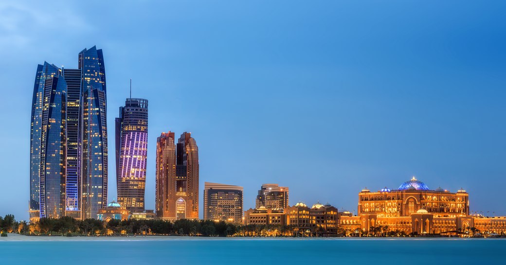 luxurious hotels lit up standing tall offering a wonderful view of the Abu Dhabi Skyline at sunset 