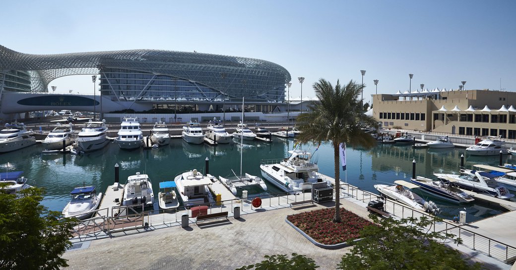 Trackside berths at Abu Dhabi Grand Prix, multiple motor yachts moored in Yas Marina.