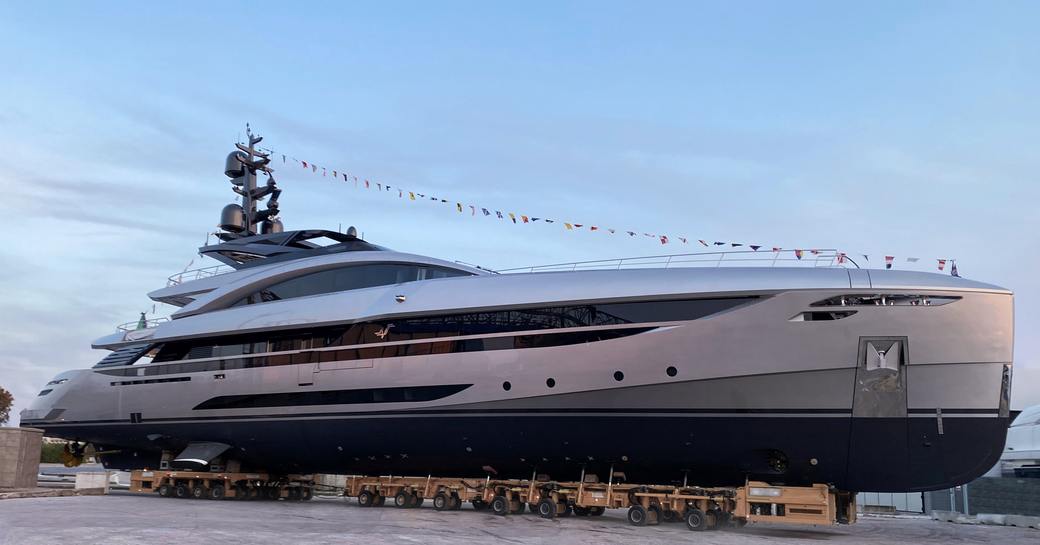 Landscape ground view of M/Y NO STRESS TWO sitting on the dock at twilight.