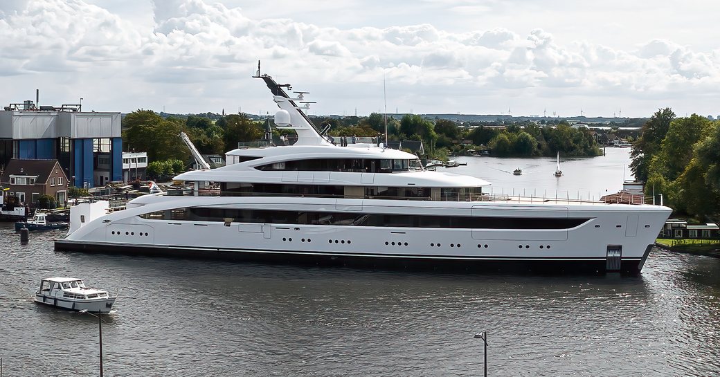 Feadship 'Project 822' being escorted away from construction shed in Kaag, Netherlands.