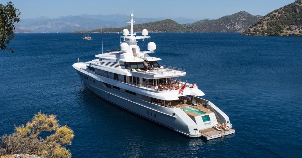 superyacht AXIOMA anchors in idyllic Mediterranean anchorage on a luxury yacht charter