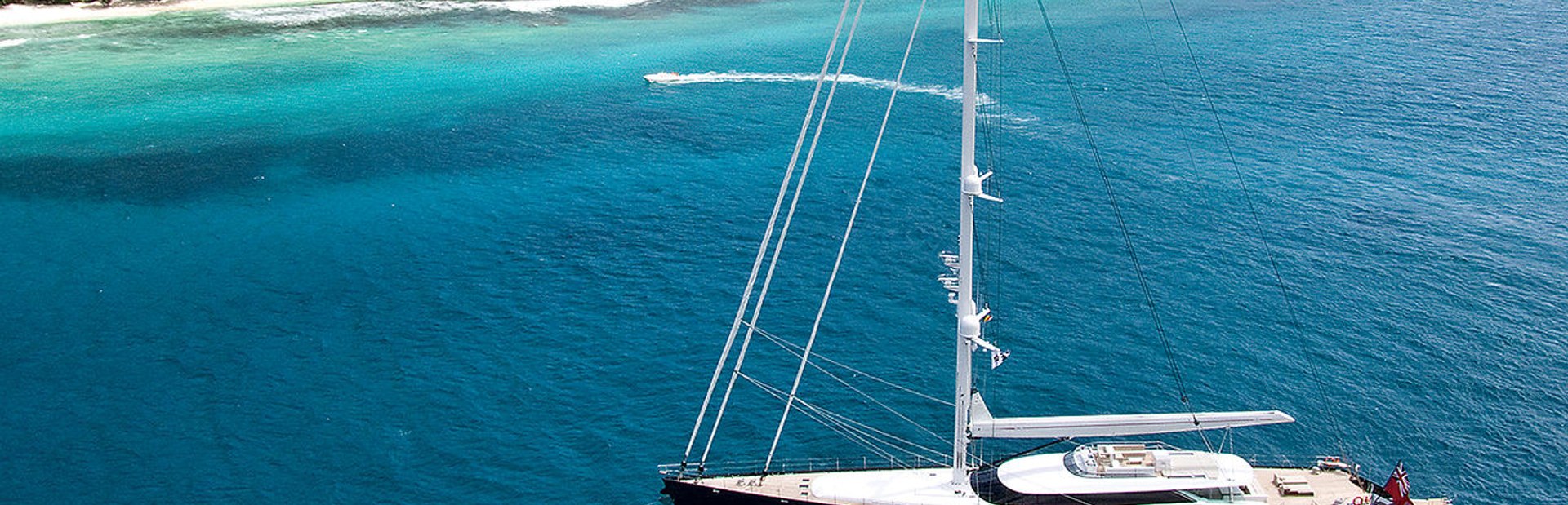 An Allloy Yachts charter superyacht at anchore off tropical island