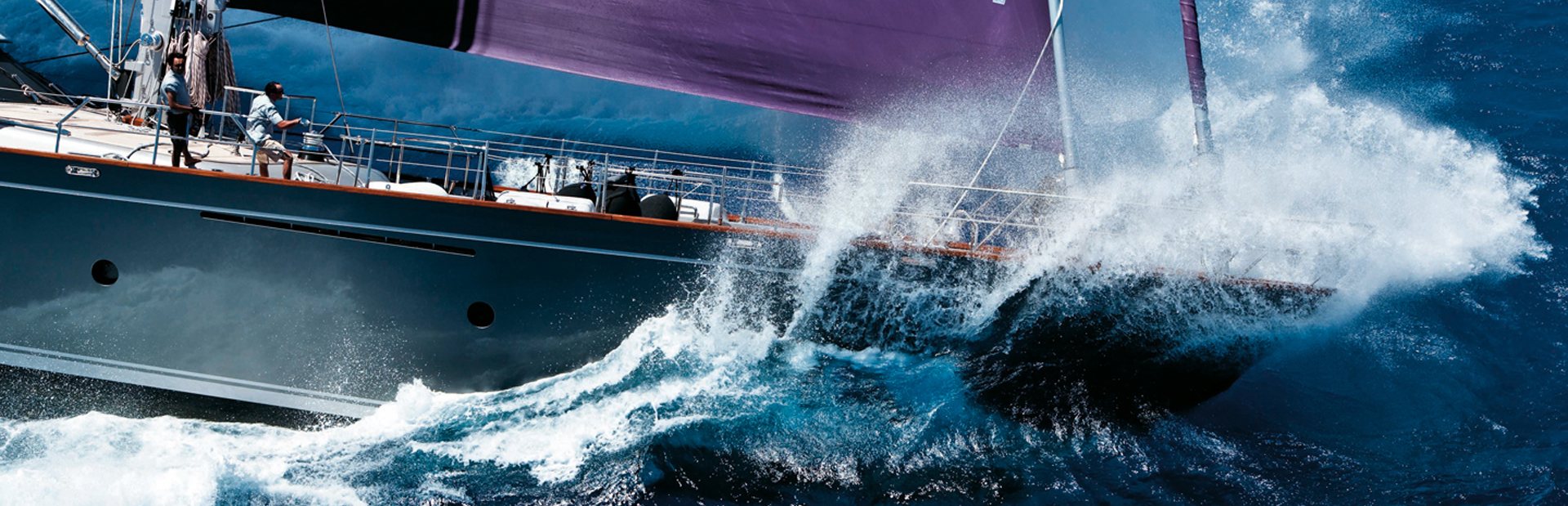 Wave splashing over the bow of yacht in Perini Navi yacht on charter for regatta