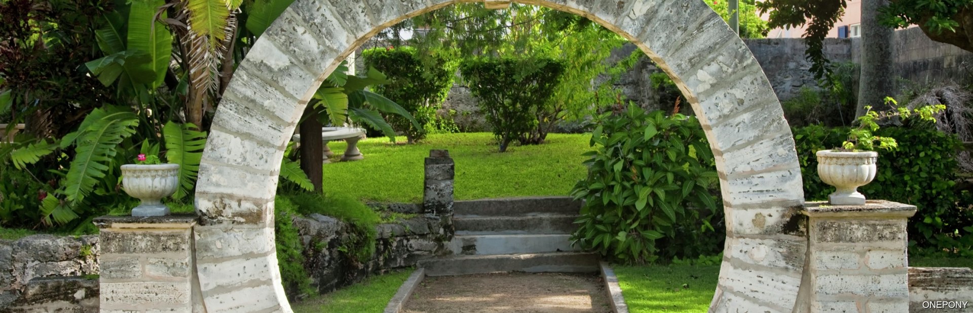 Beautiful moongate leading to green park