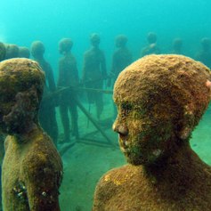 Underwater circle formed by sculptures of children